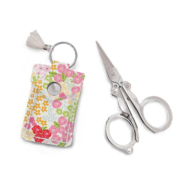 Image of the Leather Scissor Pouch Picnic Florals by Sandy Gervais for Riley Blake Designs. Features a white case with pink flowers on it. 
Cute Little Fabric Shop