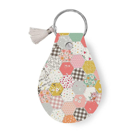 Image of the Leather Circle Key Chain Boomberry by Minki Kim for Riley Blake Designs. Features a hexagon design on a full grain leather keychain with tassle. 
Cute Little Fabric Shop