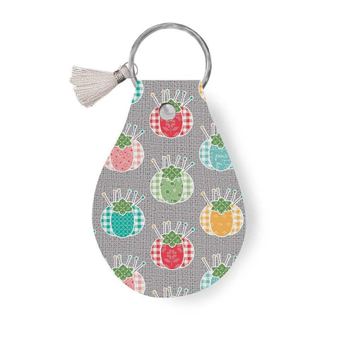 Image of the Leather Circle Key Chain My Happy Place Pincushions by Ashley Collett for Riley Blake Designs. Features a pincushion design on a full grain leather keychain with tassel. 
Cute Little Fabric Shop