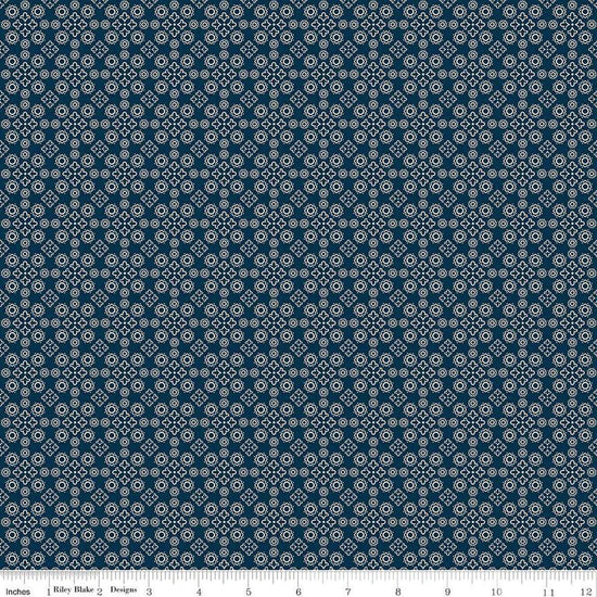 Image of the Cheddar at Twilight Medallion Navy quilting cotton fabric by Riley Blake Designs. Features geometric medallion pattern on a dark orange background. 
Cute Little Fabric Shop