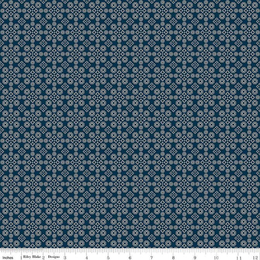 Image of the Cheddar at Twilight Medallion Navy quilting cotton fabric by Riley Blake Designs. Features geometric medallion pattern on a dark orange background. 
Cute Little Fabric Shop