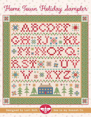 Image of the It&#39;s Sew Emma Home Town Sampler Quilt Pattern by Lori Holt for Riley Blake Designs. Features a quilt with the alphabet and a green border. 
Cute Little Fabric Shop