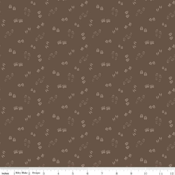 Image of the Lets Get Lost in the Woods Tracks Brown quilting cotton fabric by Tara Reed for Riley Blake Designs. Features tone on tone animal tracks on a dark brown background. 
Cute Little Fabric Shop