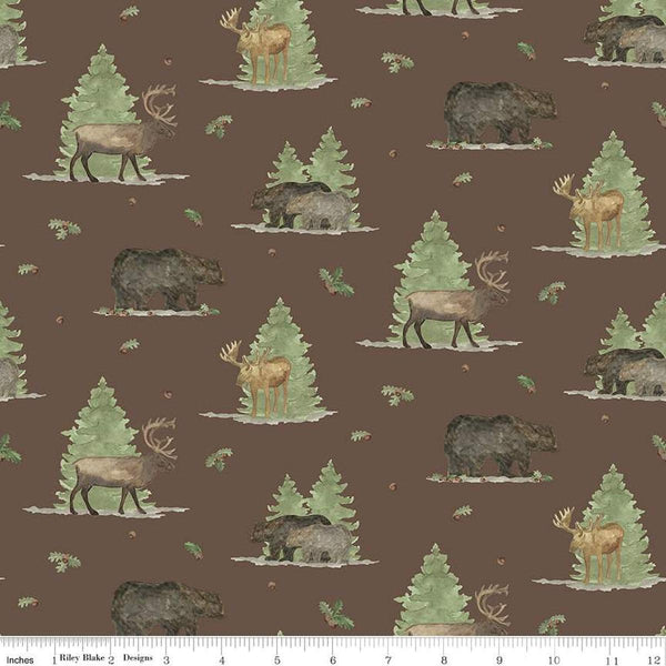 Image of the Lets Get Lost in the Woods Main Brown quilting cotton fabric by Tara Reed for Riley Blake Designs. Features  big game animals on a background with trees and oak leaves and acorns on a dark brown background. 
Cute Little Fabric Shop