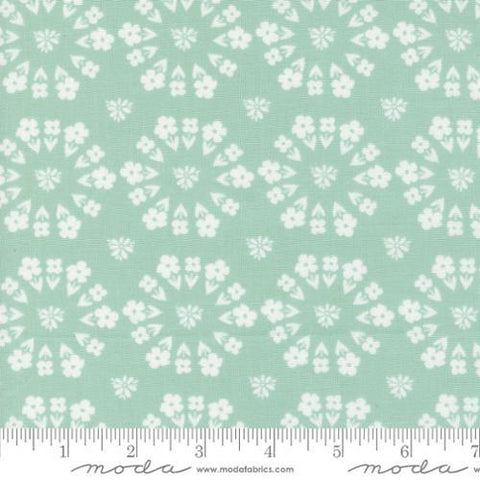 Image of the Laguna Sunrise Paradise Florals Home Town Sky quilting cotton fabric by Sherri & Chelsi for Moda Fabrics. Features small circular flowers on a light mint background. 
Cute Little Fabric Shop