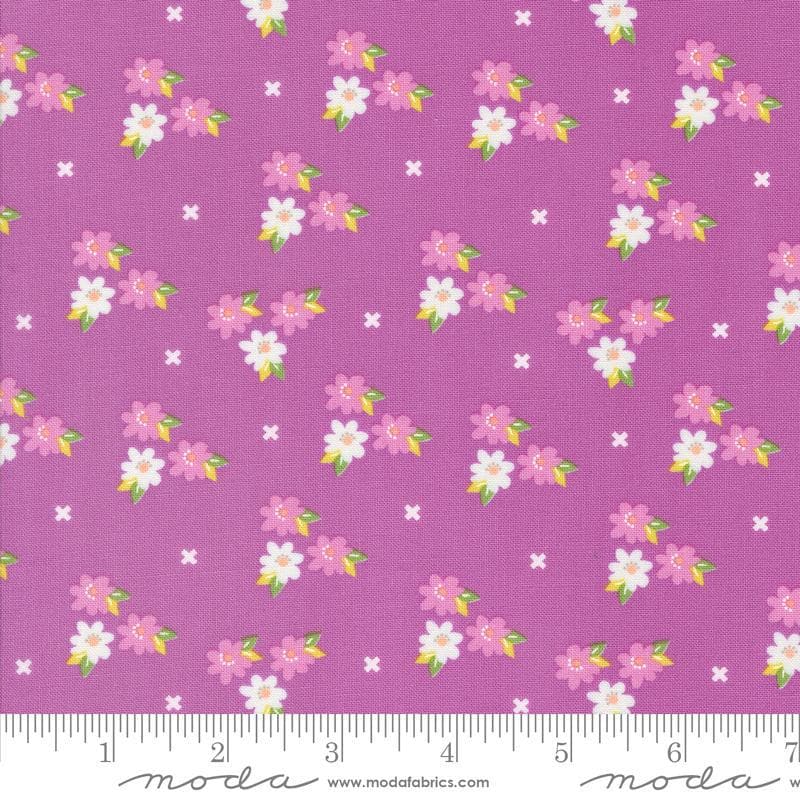 Image of the Laguna Sunrise Blossoms Violet quilting cotton fabric by Sherri & Chelsi for Moda Fabrics. Features small flowers on a bright purple background. 
Cute Little Fabric Shop