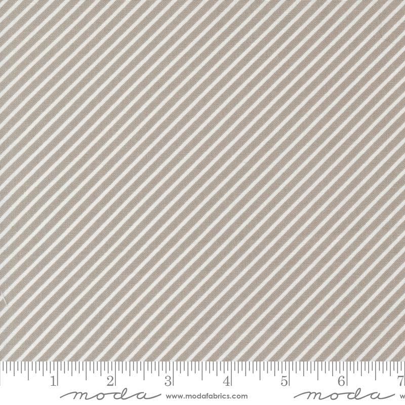 Image of the Laguna Sunrise Stripes Stone quilting cotton fabric by Sherri & Chelsi for Moda Fabrics. Features diagonal stripes on a gray background. 
Cute Little Fabric Shop