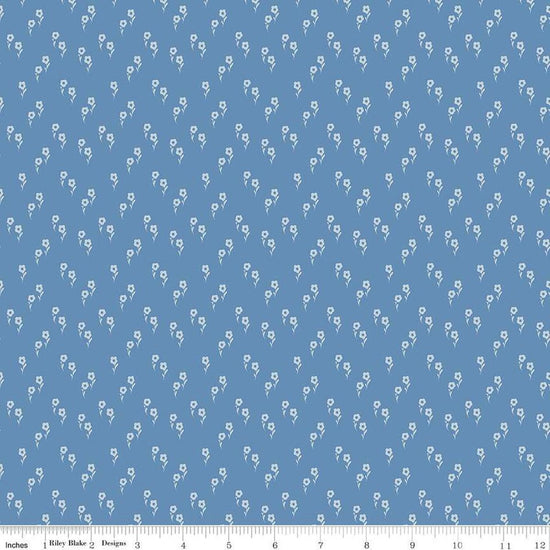 Image of the Wanderlust Jasmine Dusk quilting cotton fabric by Danelys Sidron for Riley Blake Designs. Features an array of flowers on a dusty blue background. 
Cute Little Fabric Shop