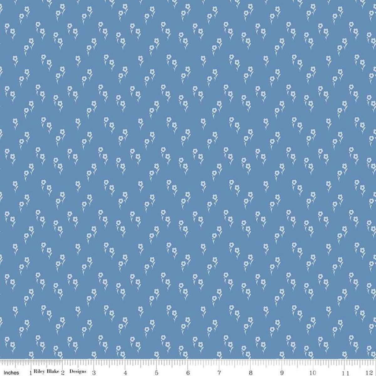 Image of the Wanderlust Jasmine Dusk quilting cotton fabric by Danelys Sidron for Riley Blake Designs. Features an array of flowers on a dusty blue background. 
Cute Little Fabric Shop