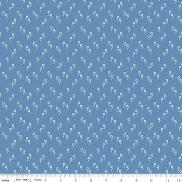 Image of the Wanderlust Jasmine Dusk quilting cotton fabric by Danelys Sidron for Riley Blake Designs. Features an array of flowers on a dusty blue background. 
Cute Little Fabric Shop