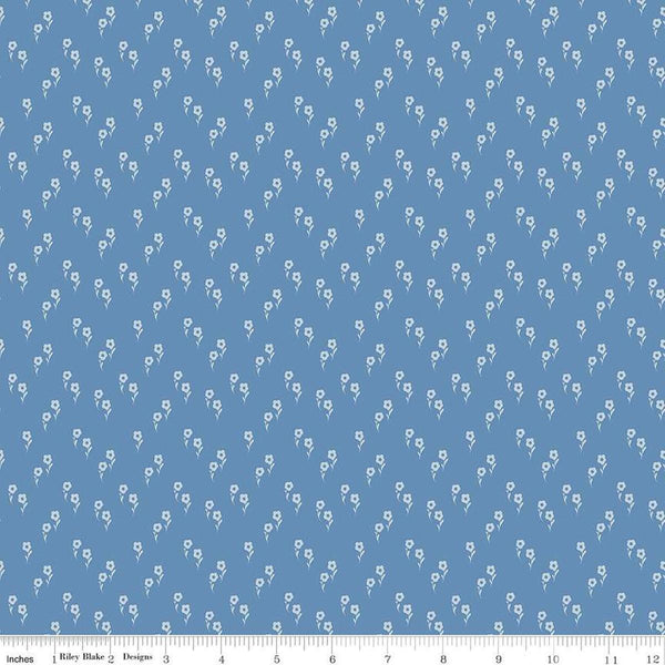 Image of the Wanderlust Jasmine Dusk quilting cotton fabric by Danelys Sidron for Riley Blake Designs. Features an array of flowers on a dusty blue background. 
Cute Little Fabric Shop