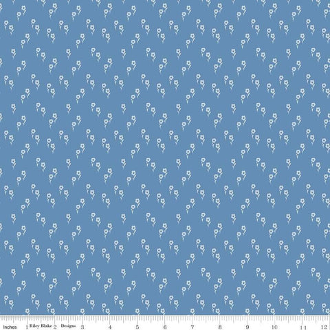 Image of the Wanderlust Jasmine Dusk quilting cotton fabric by Danelys Sidron for Riley Blake Designs. Features an array of flowers on a dusty blue background. 
Cute Little Fabric Shop