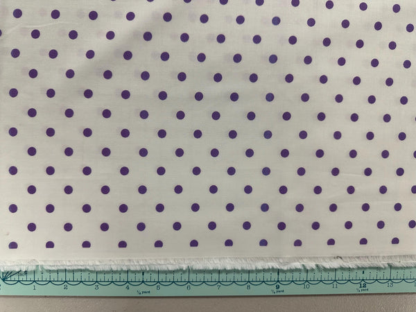 a piece of cloth with purple dots on it