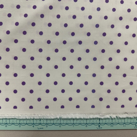 a piece of cloth with purple dots on it