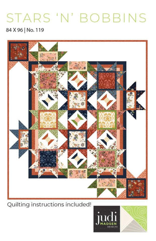 Image of the Stars &#39;n&#39; Bobbins quilt pattern by Judy Madsen for Riley Blake Designs. Features tread spools and star blocks on a quilt. 
Cute Little Fabric Shop