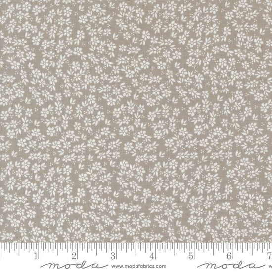 Image of the Laguna Sunrise Small Flowers Stone quilting cotton fabric by Sherri & Chelsi for Moda Fabrics. Features small scattered flowers on a gray background. 
Cute Little Fabric Shop