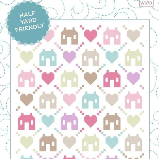 Image of the Friendly Neighborhood quilt pattern by Wendy Sheppard for Riley Blake Designs. Features houses and hearts on a white quilt pattern. 
Cute Little Fabric Shop
