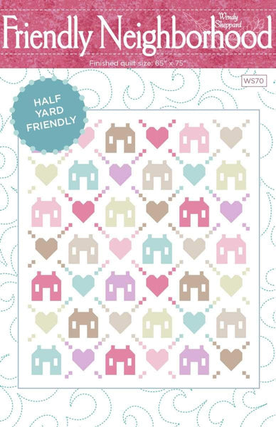 Image of the Friendly Neighborhood quilt pattern by Wendy Sheppard for Riley Blake Designs. Features houses and hearts on a white quilt pattern. 
Cute Little Fabric Shop