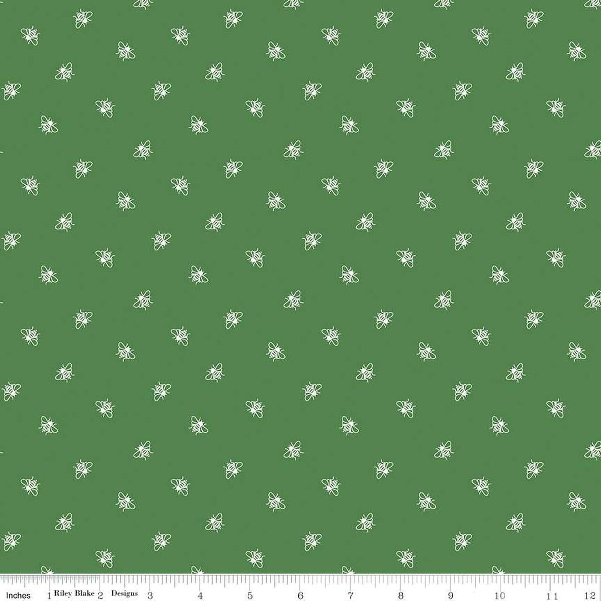 Image of the Perennial Bees Clover quilting cotton fabric by Jill Finley for Riley Blake Designs. Features small bees scattered on a green background. 
Cute Little Fabric Shop