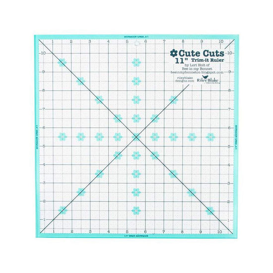 Image of the Cute Cuts™ Trim-it™ Ruler 11 inch; x 11 inch; by Lori Holt for Riley Blake Designs. Features a 11 inch square ruler with aqua borders. 
Cute Little Fabric Shop