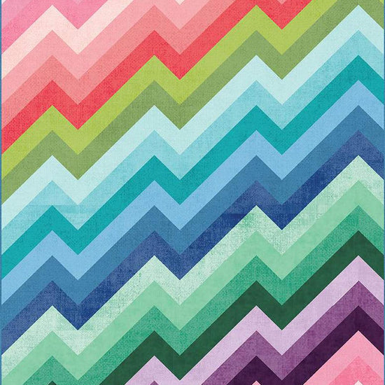 Image of the Kenzie Quilt Pattern by Purple Daisy Quilt Designs for Riley Blake Designs. Features half square triangles that create a rainbow of elongated chevron stripes. 
Cute Little Fabric Shop