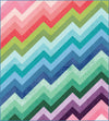 Image of the Kenzie Quilt Pattern by Purple Daisy Quilt Designs for Riley Blake Designs. Features half square triangles that create a rainbow of elongated chevron stripes. 
Cute Little Fabric Shop