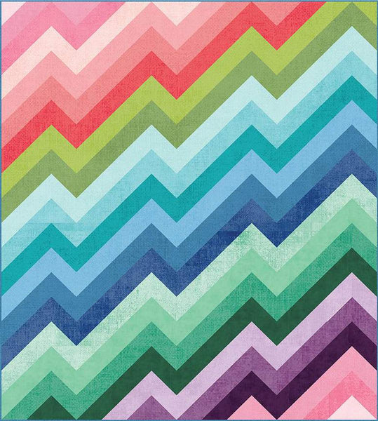 Image of the Kenzie Quilt Pattern by Purple Daisy Quilt Designs for Riley Blake Designs. Features half square triangles that create a rainbow of elongated chevron stripes. 
Cute Little Fabric Shop