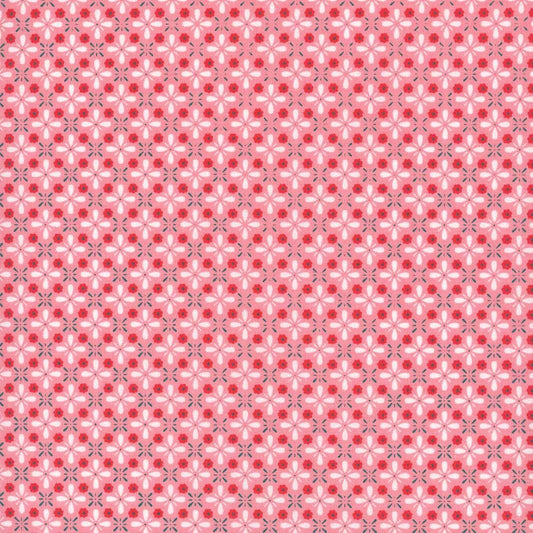 Image of the Farm Girl Vintage Vintage Coral quilting cotton fabric by Lori Holt for Riley Blake Designs. Features a geometric print of repeating flower petals on a coral pink background. 
Cute Little Fabric Shop