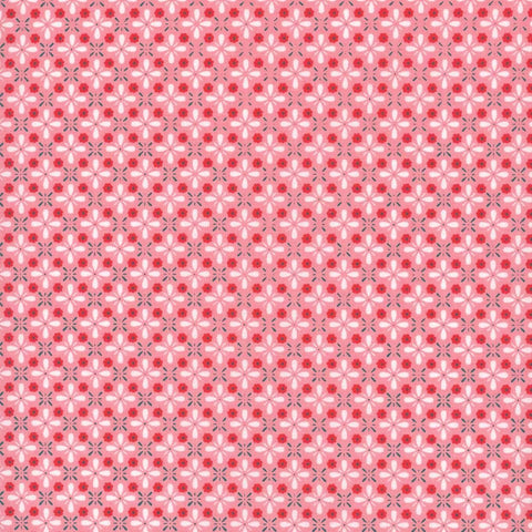 Image of the Farm Girl Vintage Vintage Coral quilting cotton fabric by Lori Holt for Riley Blake Designs. Features a geometric print of repeating flower petals on a coral pink background. 
Cute Little Fabric Shop