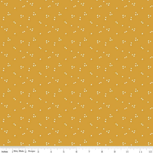 Image of the It Takes a Village Shining Star Honey quilting cotton fabric by Jennifer Long for Riley Blake Designs. Features small scattered stars on a darker yellow background. 
Cute Little Fabric Shop