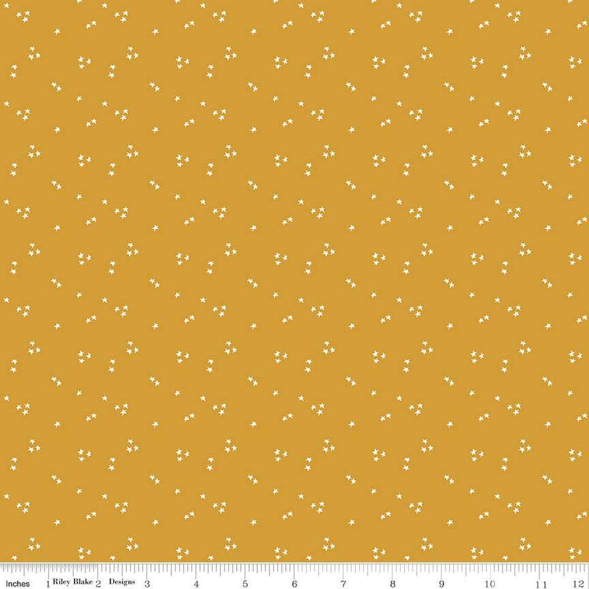 Image of the It Takes a Village Shining Star Honey quilting cotton fabric by Jennifer Long for Riley Blake Designs. Features small scattered stars on a darker yellow background. 
Cute Little Fabric Shop