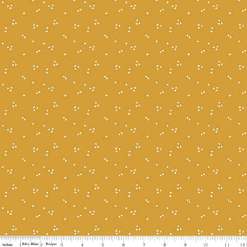 Image of the It Takes a Village Shining Star Honey quilting cotton fabric by Jennifer Long for Riley Blake Designs. Features small scattered stars on a darker yellow background. 
Cute Little Fabric Shop