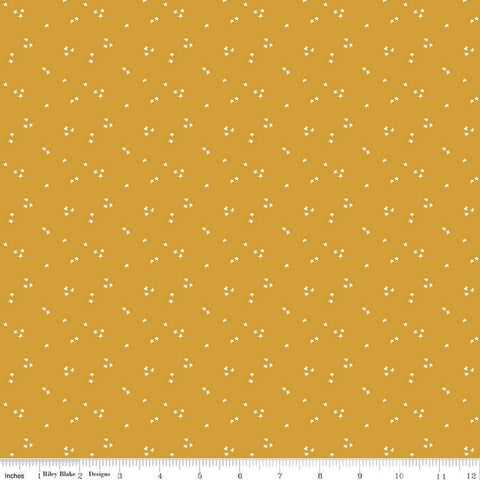 Image of the It Takes a Village Shining Star Honey quilting cotton fabric by Jennifer Long for Riley Blake Designs. Features small scattered stars on a darker yellow background. 
Cute Little Fabric Shop