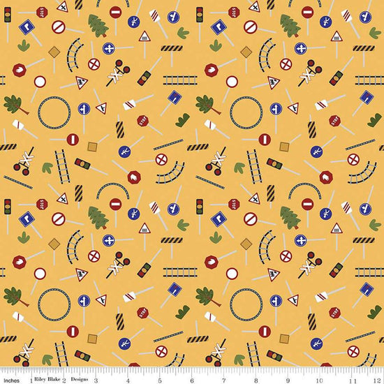 Image of the It Takes a Village Traffic Signs Sunshine quilting cotton fabric by Jennifer Long for Riley Blake Designs. Features street signs, trees, train tracks, and more on a yellow background. 
Cute Little Fabric Shop