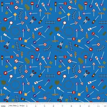 Image of the It Takes a Village Traffic Signs Blue quilting cotton fabric by Jennifer Long for Riley Blake Designs. Features street signs, trees, train tracks, and more on a blue background. 
Cute Little Fabric Shop