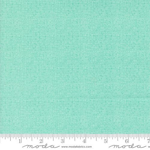 Thatched Aqua quilting cotton fabric by Gingiber for Moda Fabrics. Features a textured and lined pattern on a light aqua mint blue background. 
Cute Little Fabric Shop