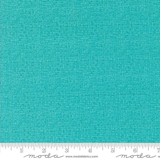 Thatched Surf quilting cotton fabric by Gingiber for Moda Fabrics. Features a textured and lined pattern on a bright aqua background. 
Cute Little Fabric Shop