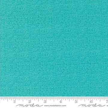 Thatched Surf quilting cotton fabric by Gingiber for Moda Fabrics. Features a textured and lined pattern on a bright aqua background. 
Cute Little Fabric Shop