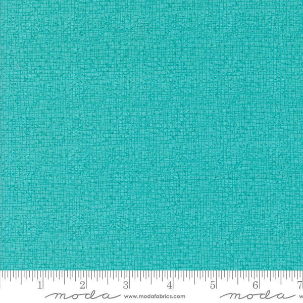 Thatched Surf quilting cotton fabric by Gingiber for Moda Fabrics. Features a textured and lined pattern on a bright aqua background. 
Cute Little Fabric Shop