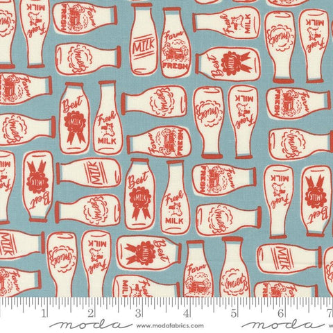 Image of the Farmstead Milk Mountain Stream quilting cotton fabric by Stacy Iest Hsu for Moda Fabrics. Features bottles of milk on a dusty blue background. 
Cute Little Fabric Shop