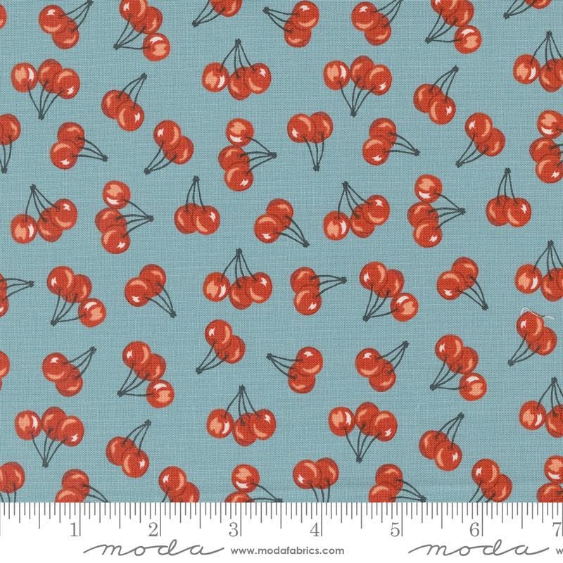 Image of the Farmstead Cherries Mountain Stream quilting cotton fabric by Stacy Iest Hsu for Moda Fabrics. Features small cherries on a dusty blue background. 
Cute Little Fabric Shop