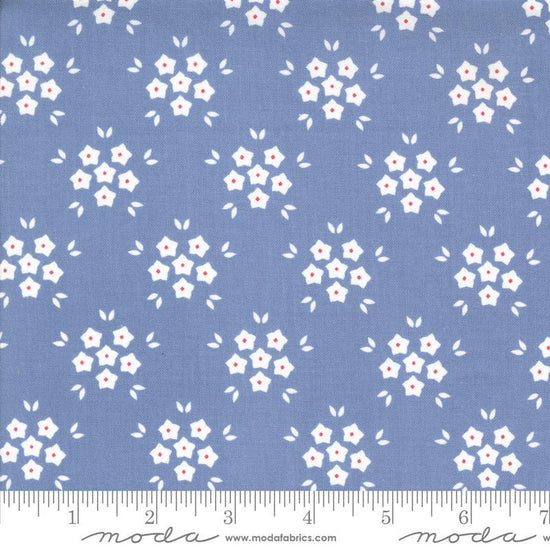 Image of the Hollyhocks Roses Puffs Sky quilting cotton fabric by Moda Fabrics. Features small flowers on a blue background. 
Cute Little Fabric Shop
