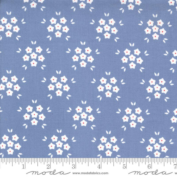 Image of the Hollyhocks Roses Puffs Sky quilting cotton fabric by Moda Fabrics. Features small flowers on a blue background. 
Cute Little Fabric Shop