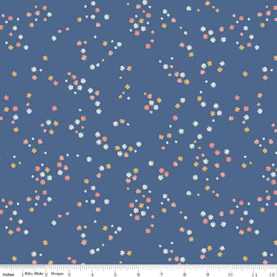 Image of the Between the Pages Flowers Denim quilting cotton fabric by Fran Gulick for Riley Blake Designs. Features scattered small flowers on a blue background. 
Cute Little Fabric Shop
