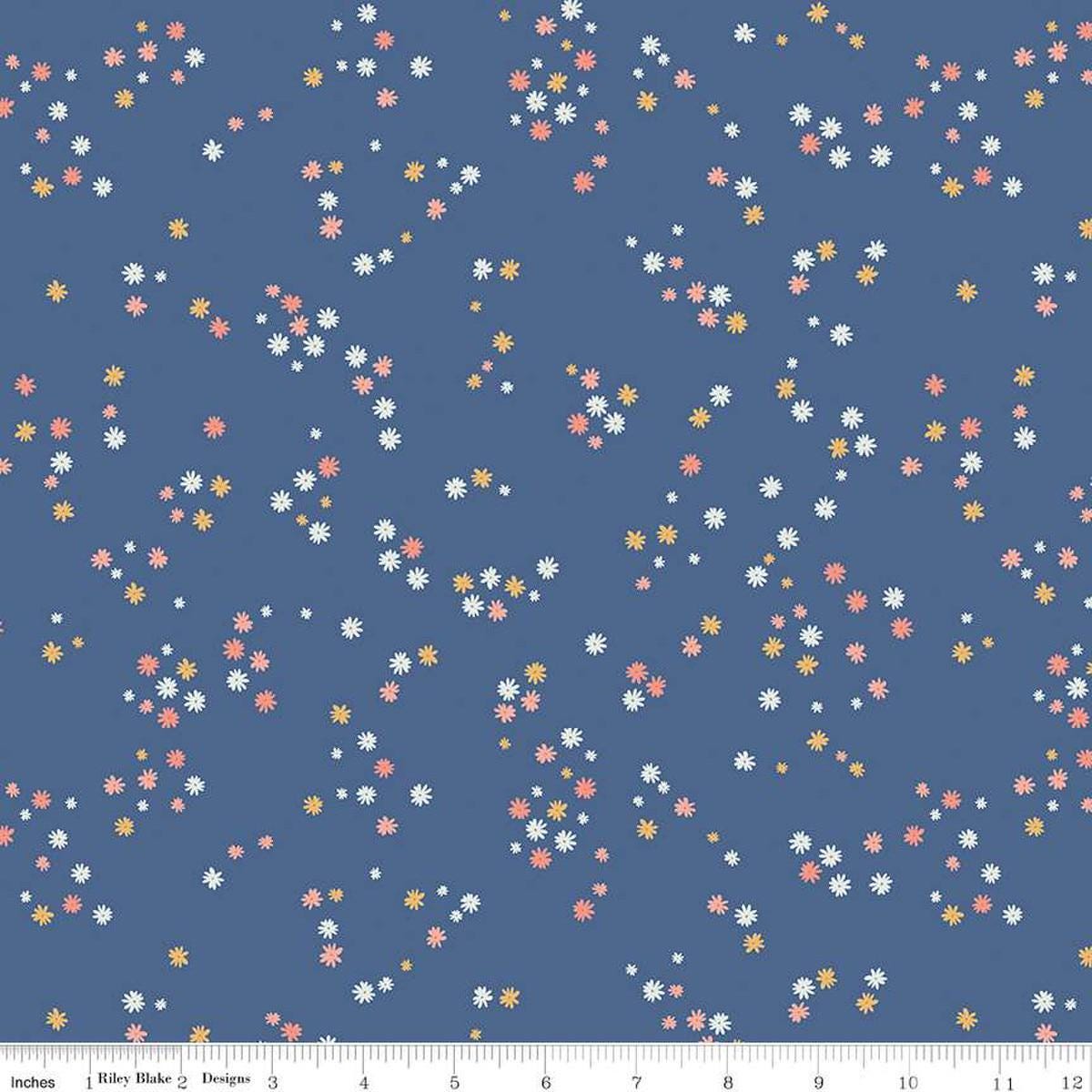 Image of the Between the Pages Flowers Denim quilting cotton fabric by Fran Gulick for Riley Blake Designs. Features scattered small flowers on a blue background. 
Cute Little Fabric Shop