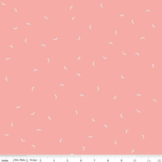 Image of the Between the Pages Open Book Coral
 quilting cotton fabric by Fran Gulick for Riley Blake Designs. Features scattered books on a light pink background. 
Cute Little Fabric Shop