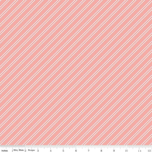 Image of the Between the Pages Stripes Coral quilting cotton fabric by Fran Gulick for Riley Blake Designs. Features diagonal small stripes on a light pink background. 
Cute Little Fabric Shop