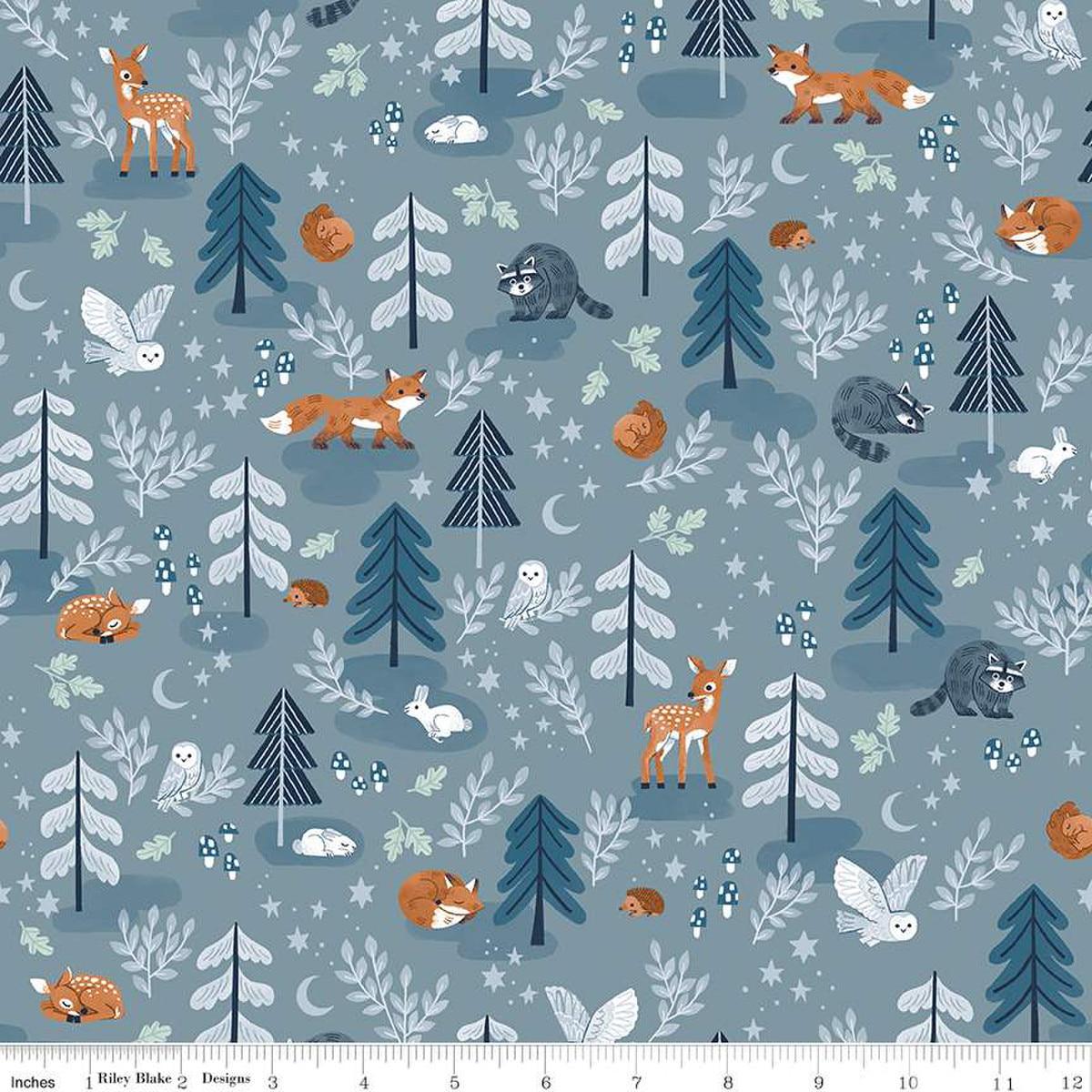 Image of the Twilight Creatures Main Storm
 quilting cotton fabric by Natàlia Juan Abelló for Riley Blake Designs. Features scattered trees, animals, stars, moons, and mushrooms on a gray blue background. 
Cute Little Fabric Shop