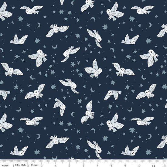 Image of the Twilight Creatures Night Owls Indigo quilting cotton fabric by Natàlia Juan Abelló for Riley Blake Designs. Features scattered owls, stars, moons, and dots on a dark blue background. 
Cute Little Fabric Shop