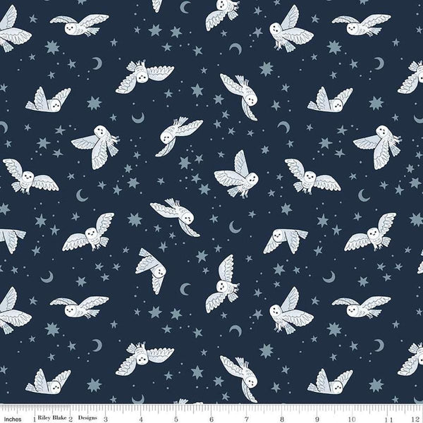 Image of the Twilight Creatures Night Owls Indigo quilting cotton fabric by Natàlia Juan Abelló for Riley Blake Designs. Features scattered owls, stars, moons, and dots on a dark blue background. 
Cute Little Fabric Shop